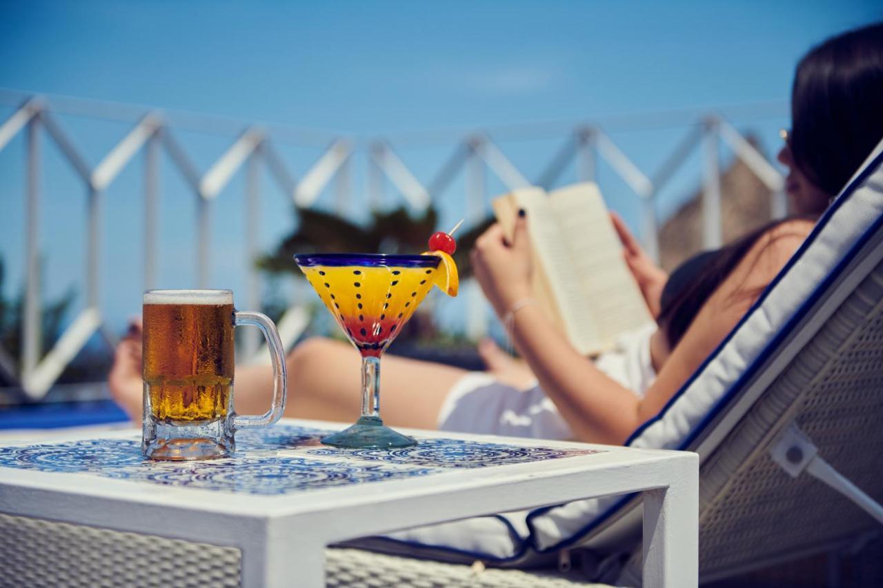 Hotel Luxury Patio Azul (Adults Only) Puerto Vallarta Exterior photo A woman reading a book by the pool
